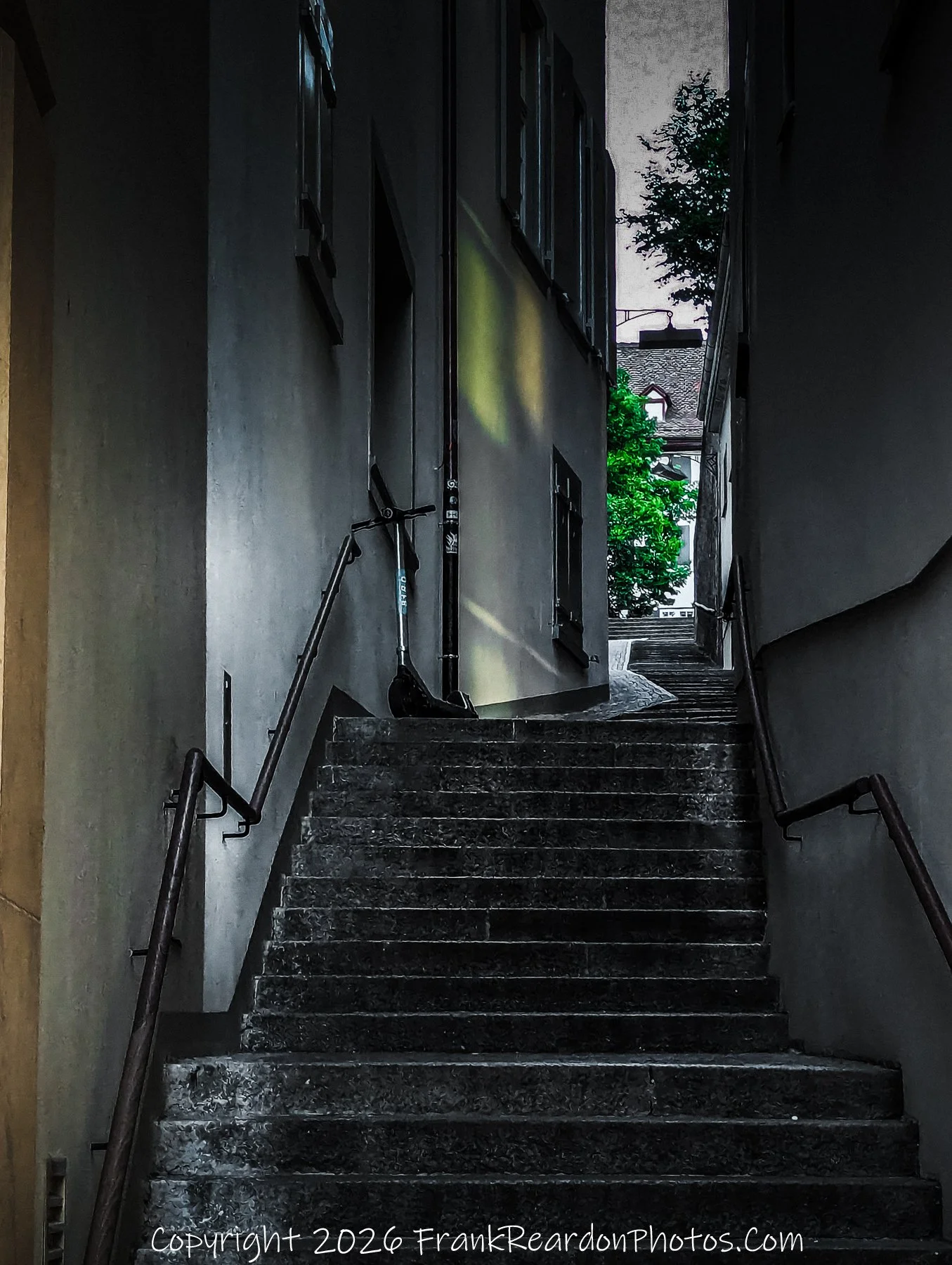 "The Urban Ascent" A steep, stone-staircase alleyway at dusk, featuring a lonely scooter leaning against a wall and a glimpse of greenery glowing against the darkening sky.