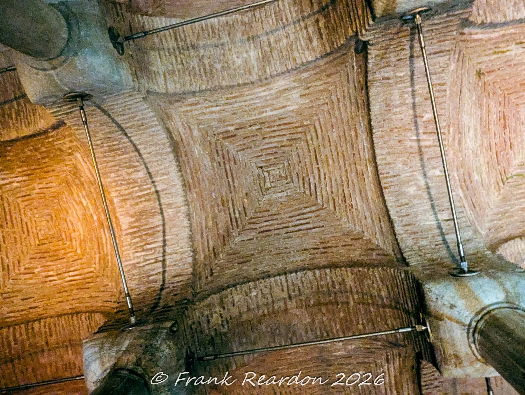 A direct overhead shot of the unique, stepped brick-vaulted ceiling patterns and structural stabilization rods in the Basilica Cistern.