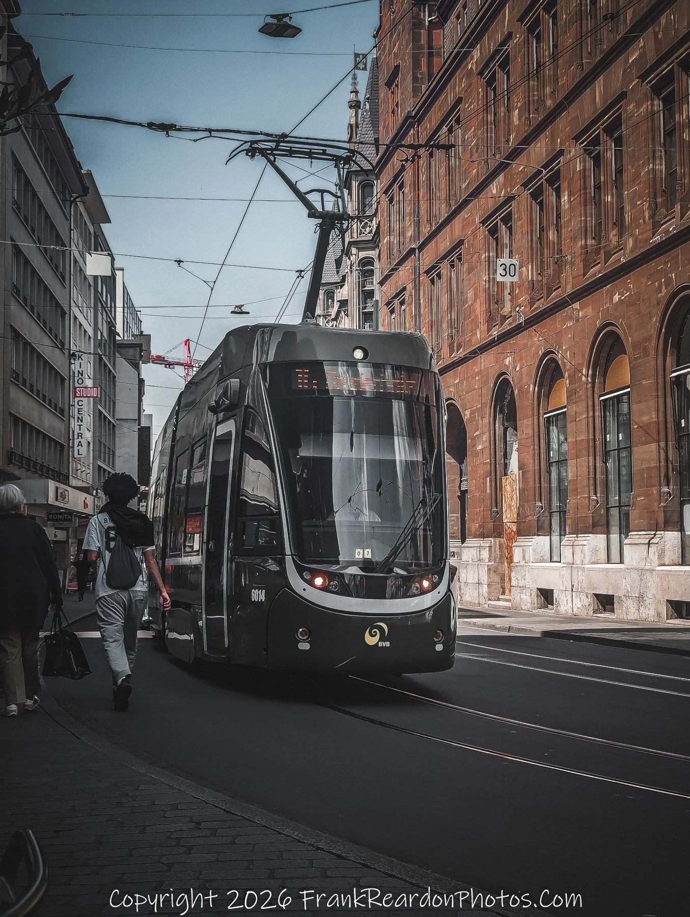 “Steel and Stone” A tram glides through Basel’s historic corridor, threading modern motion through timeless façades.