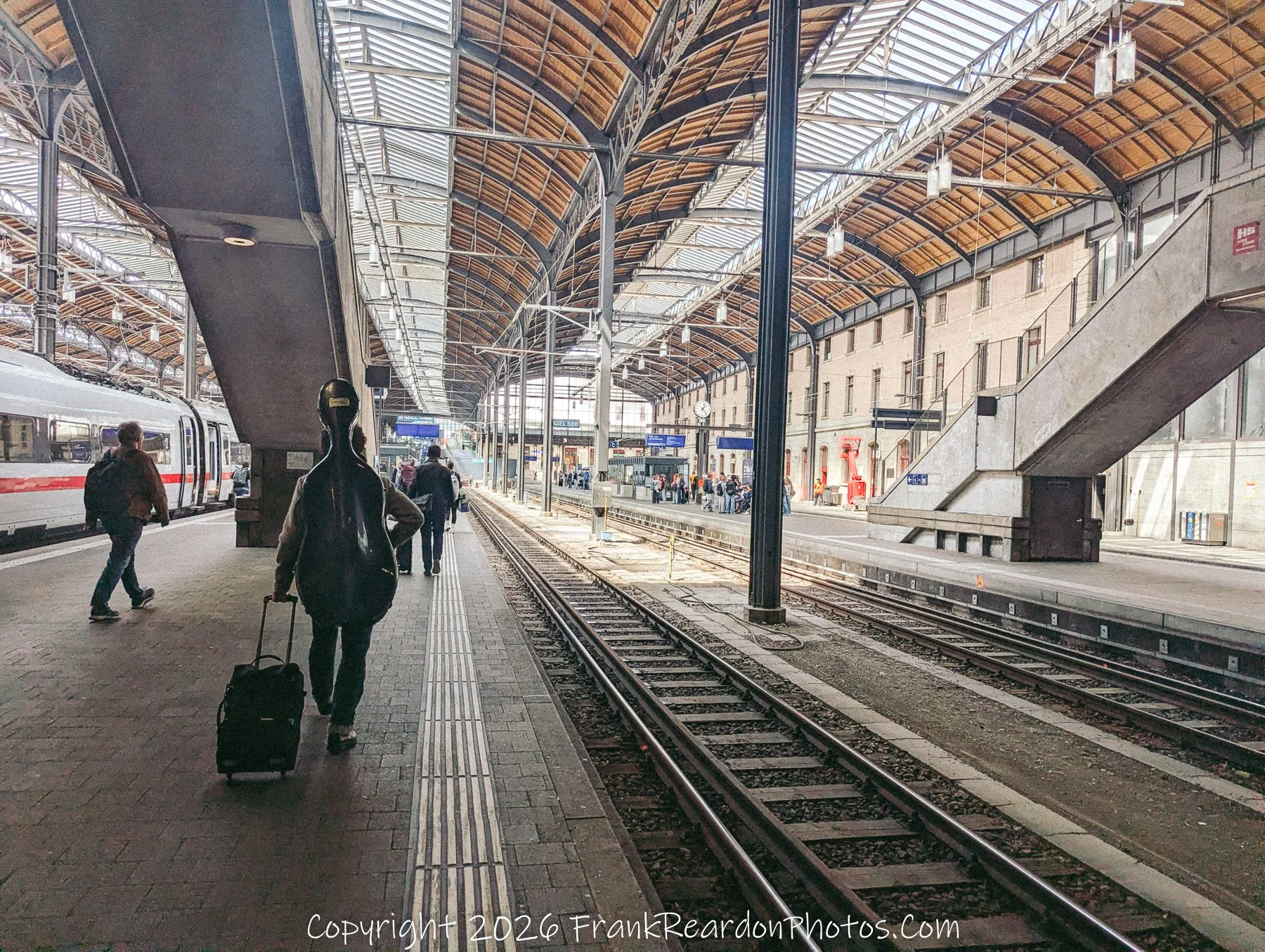 “Departure in Resonance” A traveler with a cello case moves through the station, merging music and motion beneath the vaulted roof.