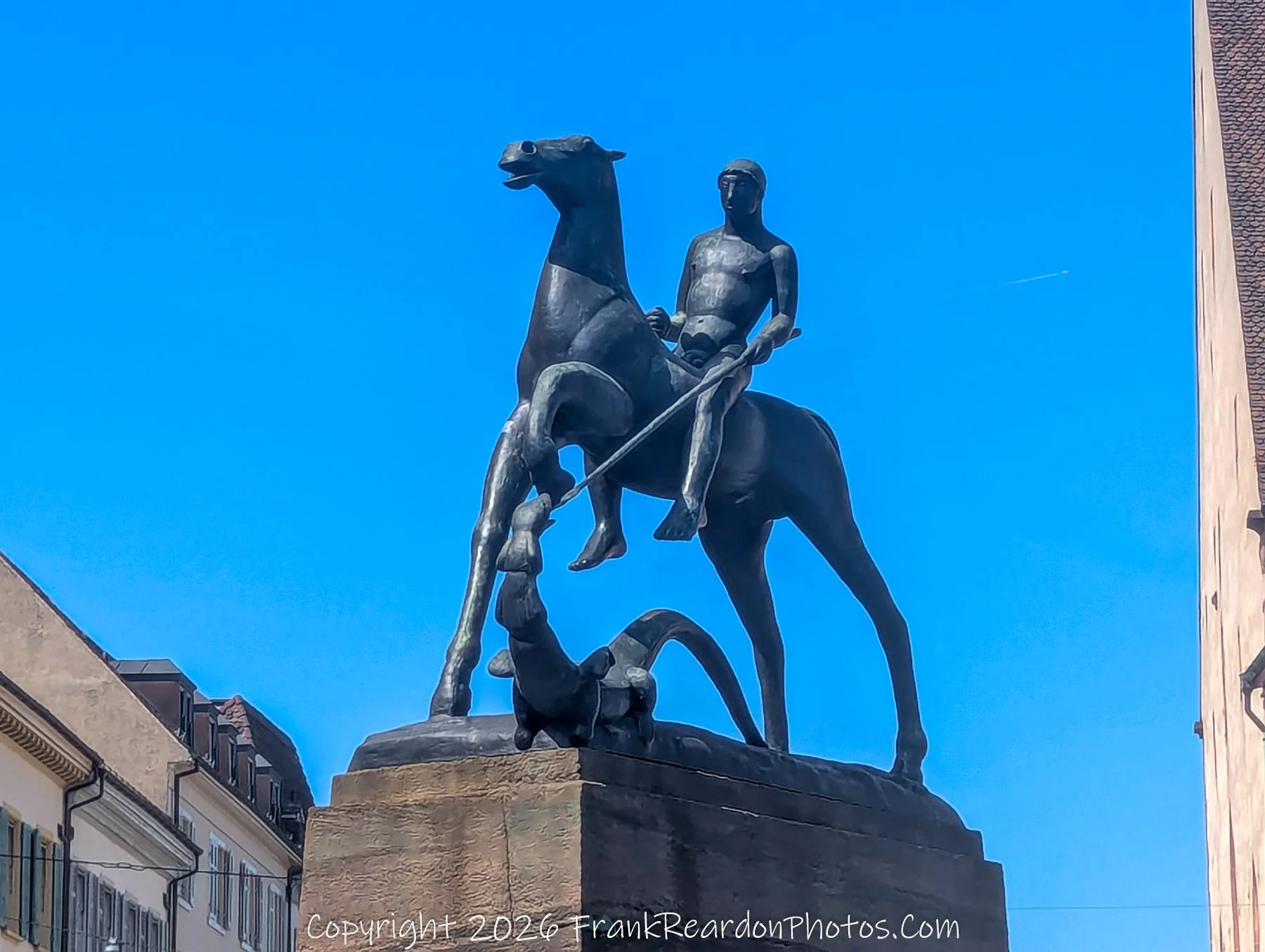 “The Rider and the Dragon” Bronze strength meets mythic struggle, a silent guardian beneath Basel’s blue sky.