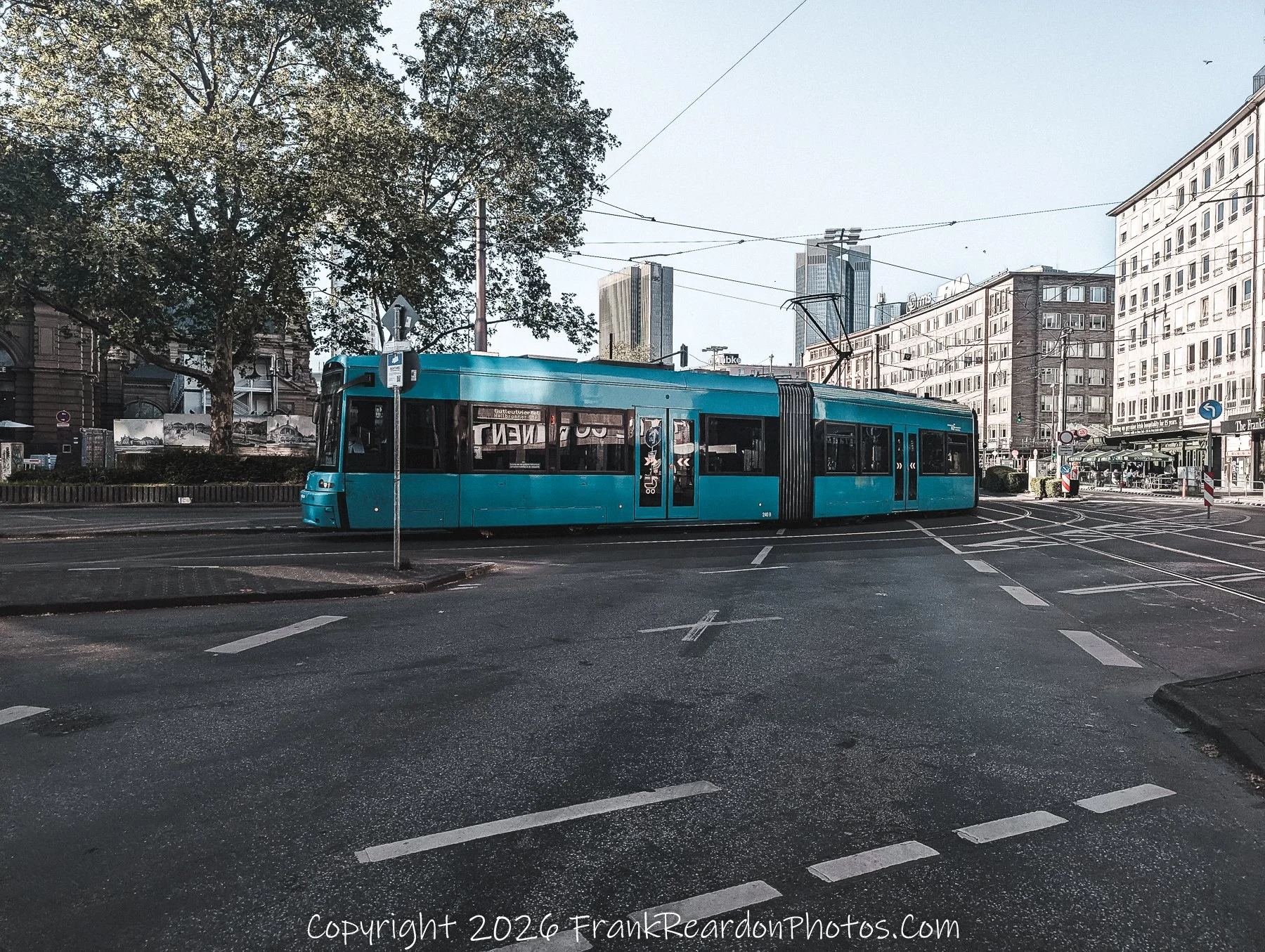 Turquoise Tram Crossing the Intersection.
Frankfurt Transit Blue