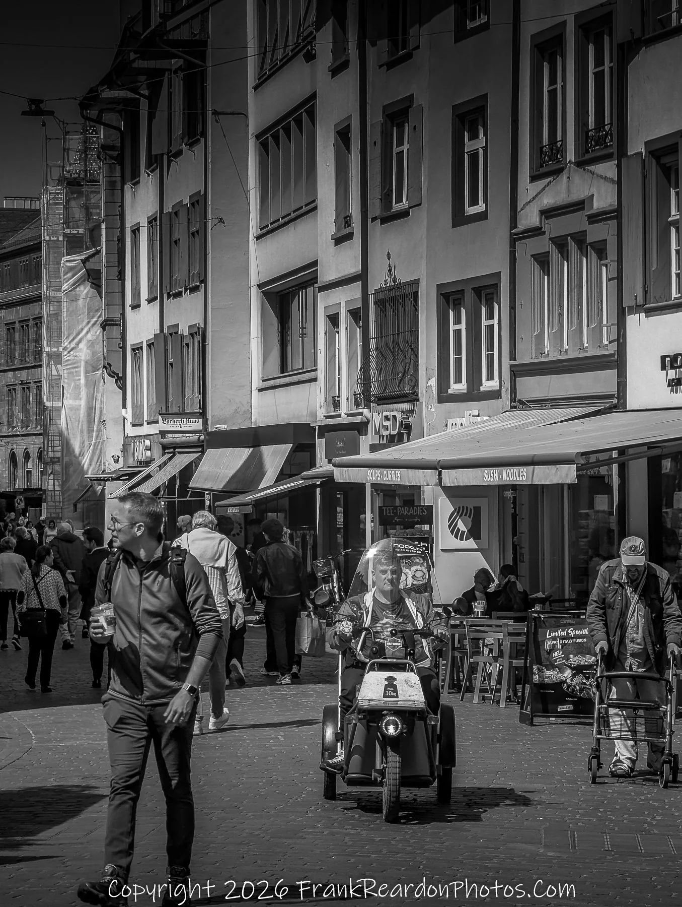 “Everyday Encounters” A moment of ordinary grace, where people and architecture merge in monochrome harmony.