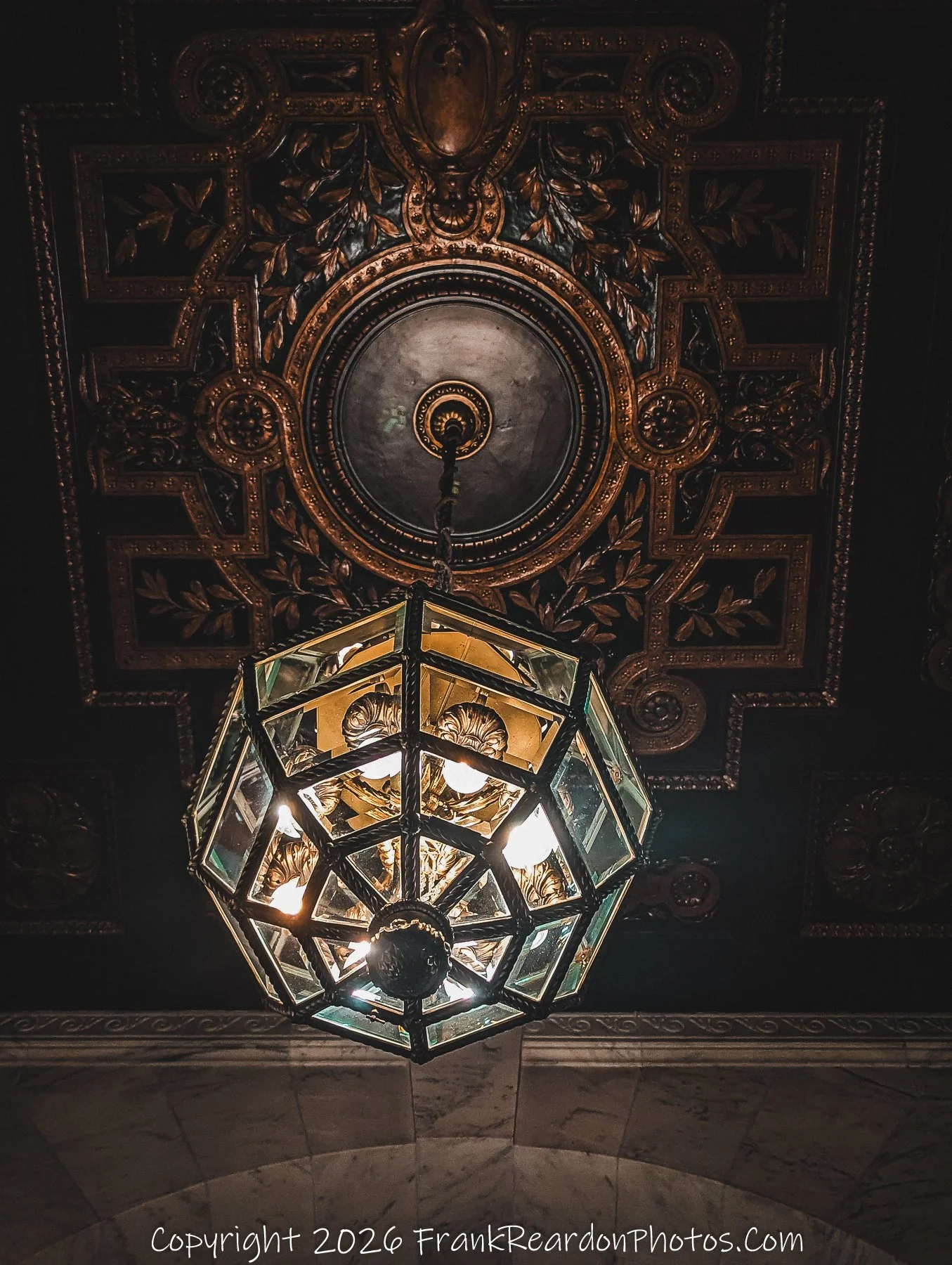 “Ornate Ceiling: Light in Gilded Detail”