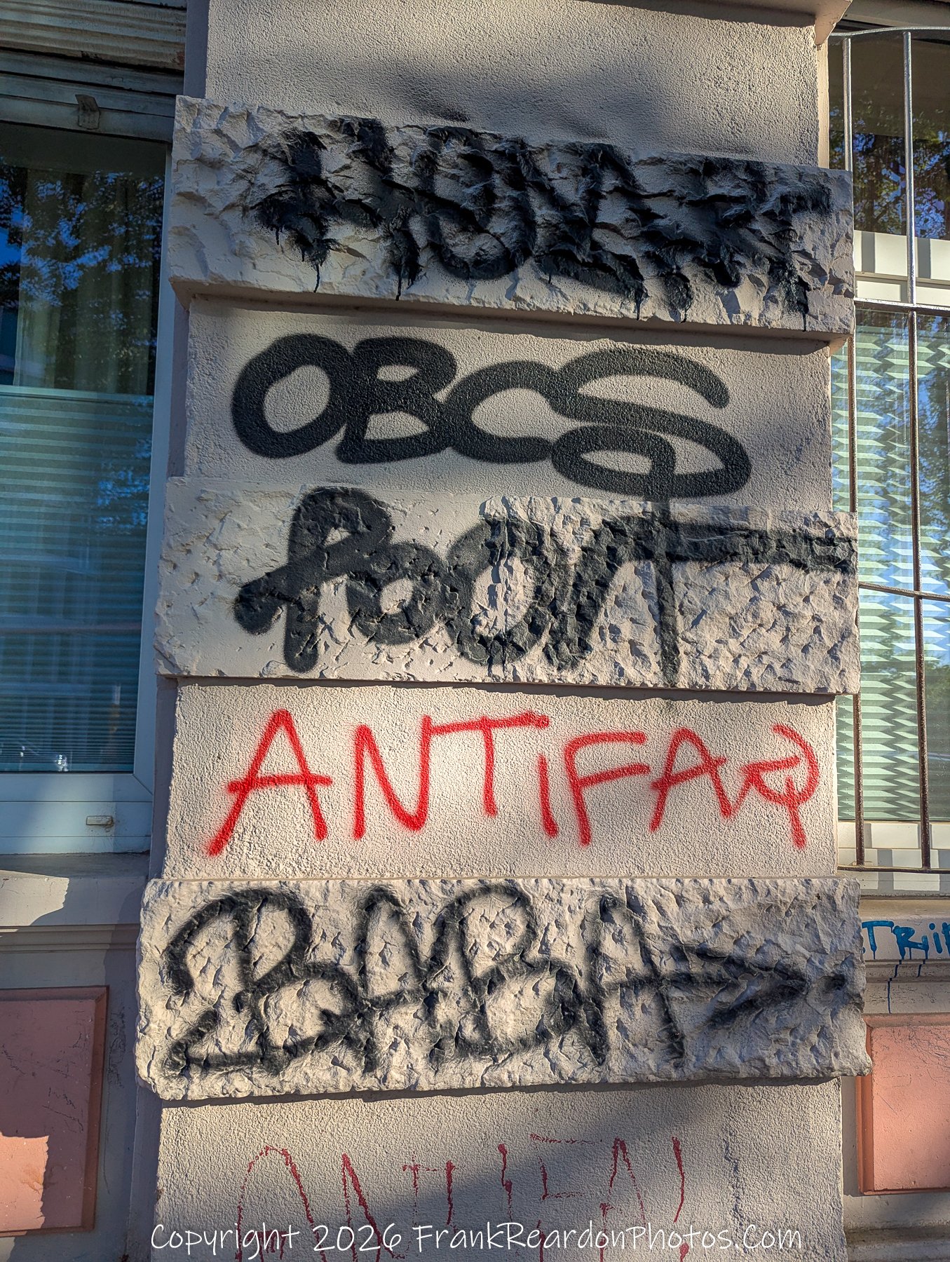 Layers of Graffiti on Textural Stone. 
Tagged Pillars