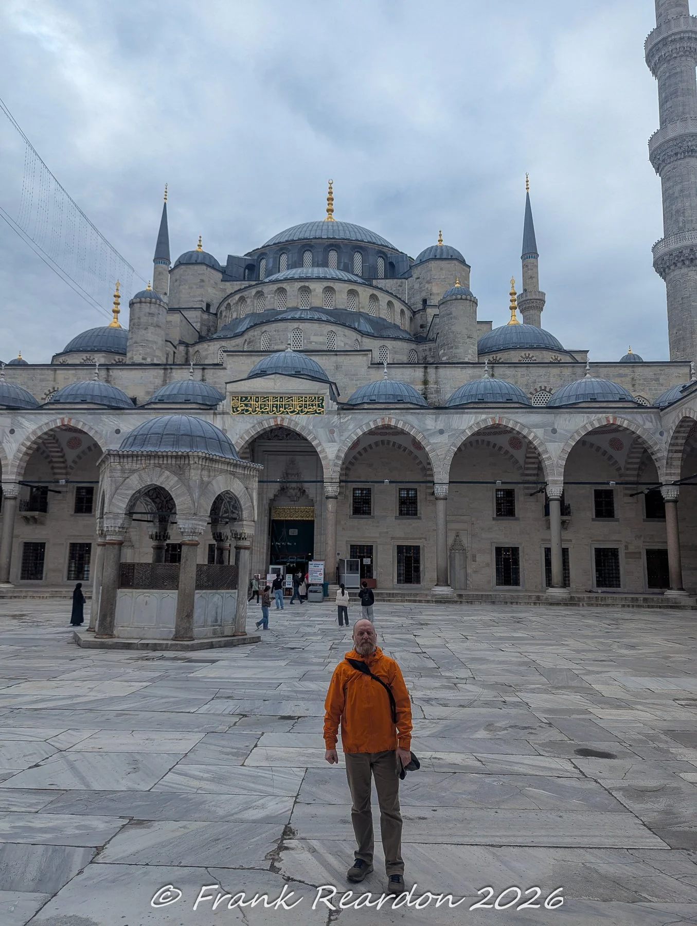 Me standing in the expansive marble courtyard of the historic Sultan Ahmed Mosque (Blue Mosque) in Istanbul.