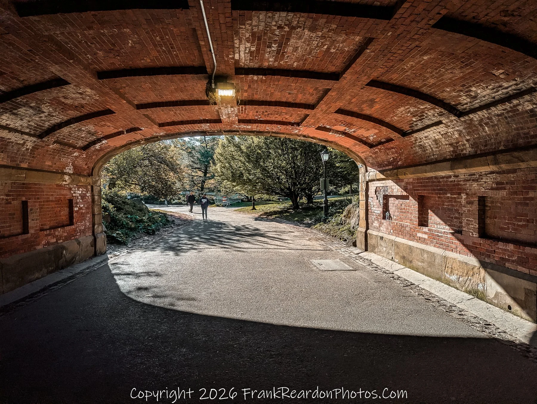 “Beneath the Brick Arch: Light and Pathways”