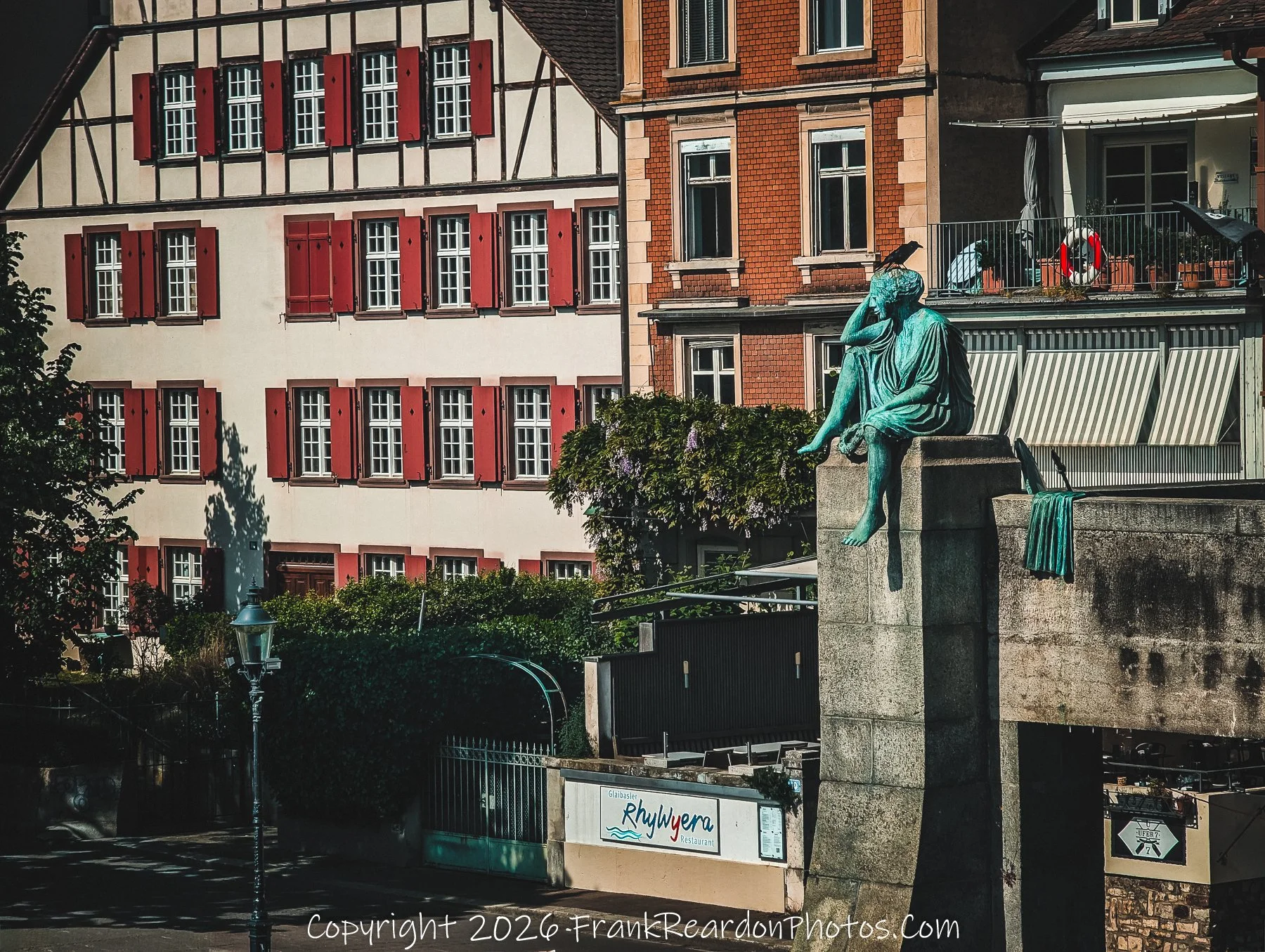 “The Thinker of Basel” A bronze figure gazes across the river, lost in the city’s eternal flow.