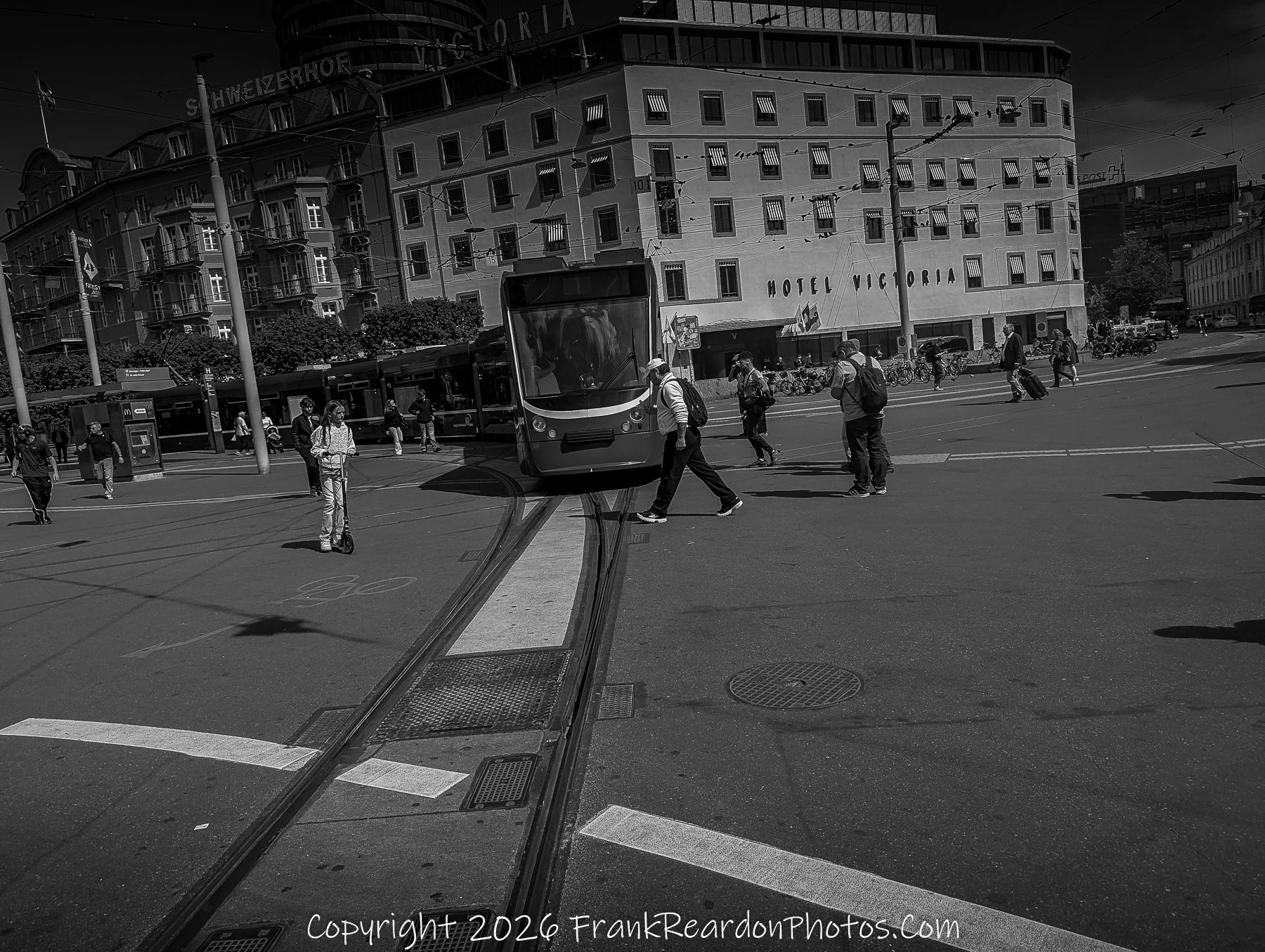 “Victoria Crossing” A monochrome moment of movement and pause at Hotel Victoria’s tram junction.