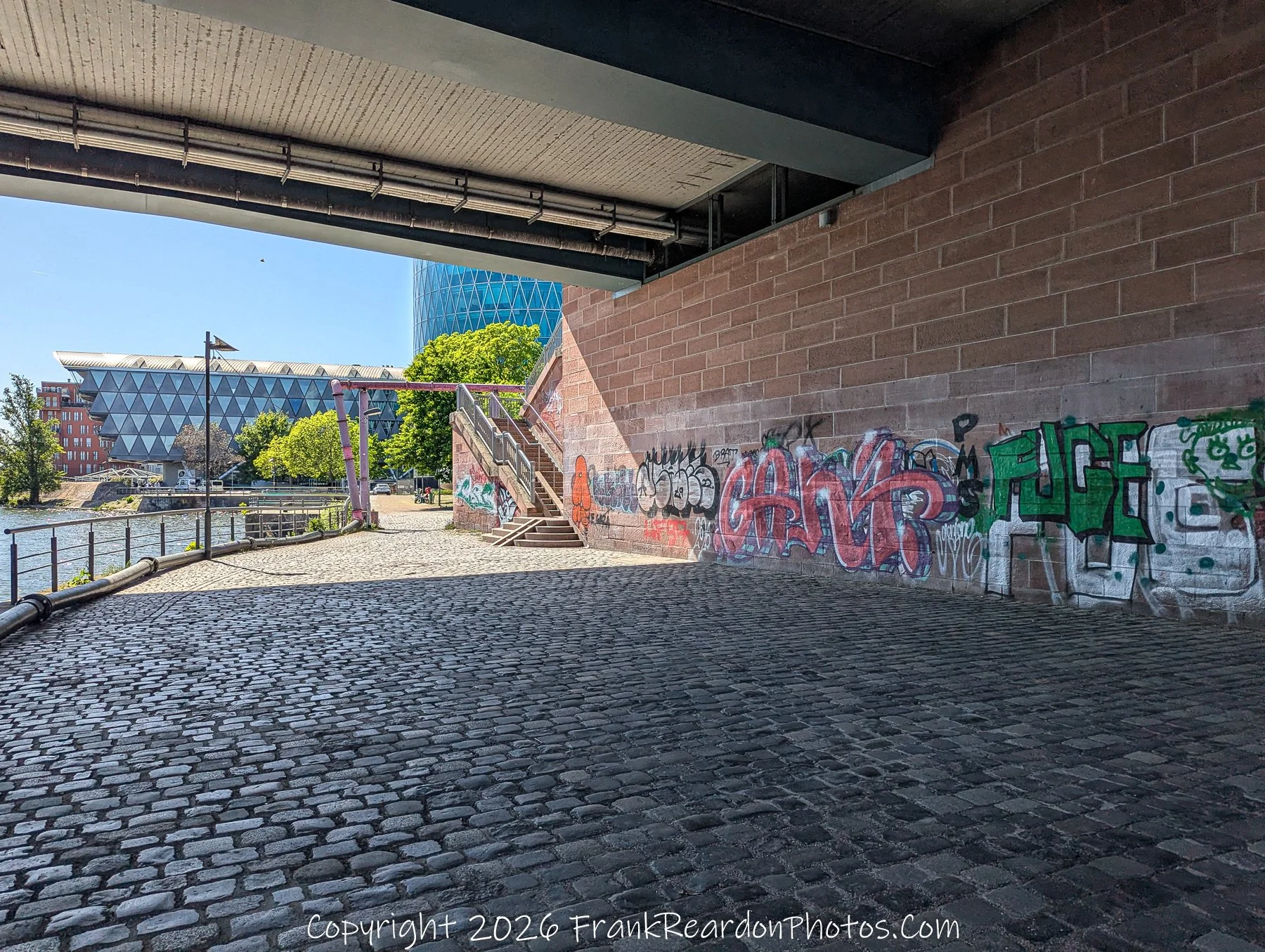 Under Bridge with View Toward Modern Architecture
“Framed Perspectives – Frankfurt Riverside”