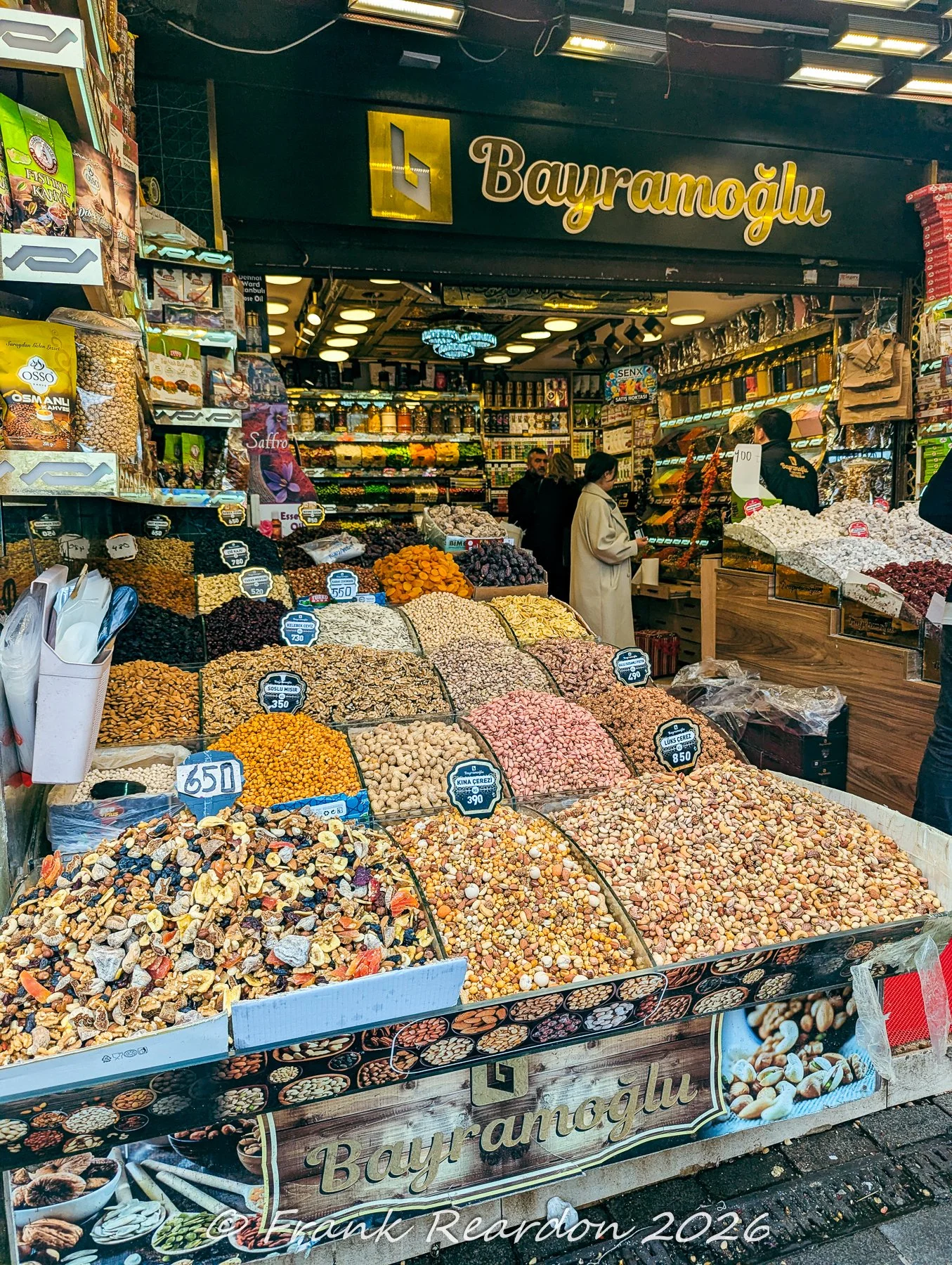 An overflowing display of colorful dried fruits, mixed nuts, and local delicacies outside the Bayramoğlu shop in Istanbul.
