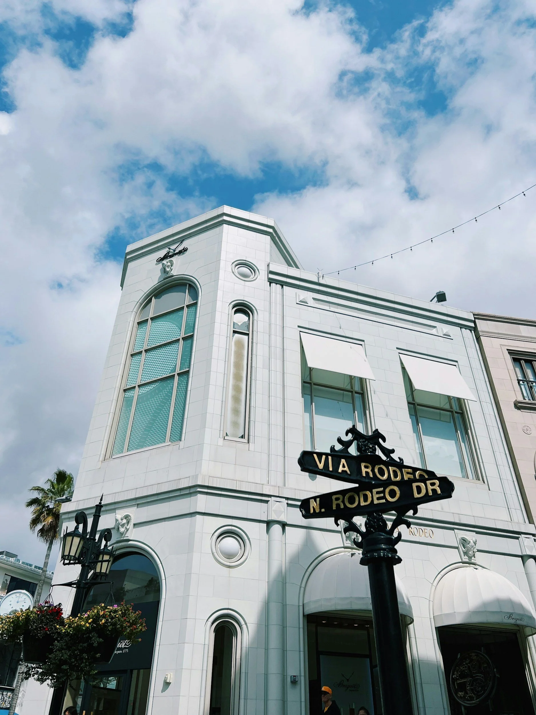 Classic white luxury architecture in Beverly Hills California showcasing intricate molding against a clear blue sky.
