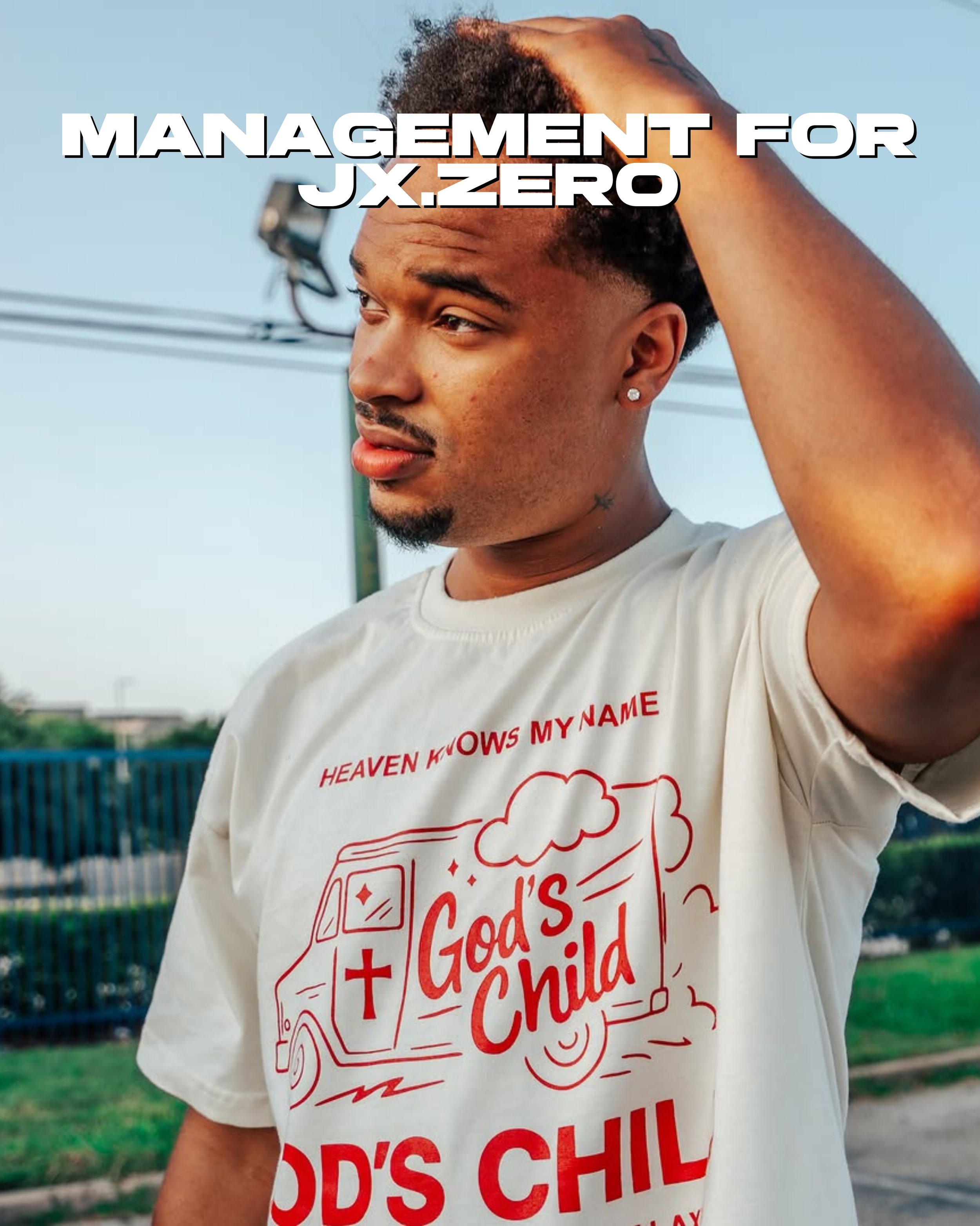Jx.Zero with a beard and earrings is outdoors, wearing a white t-shirt with red text and a graphic of a food truck, as he touches his head with one hand. The sky is clear and the background includes some greenery and a fence.