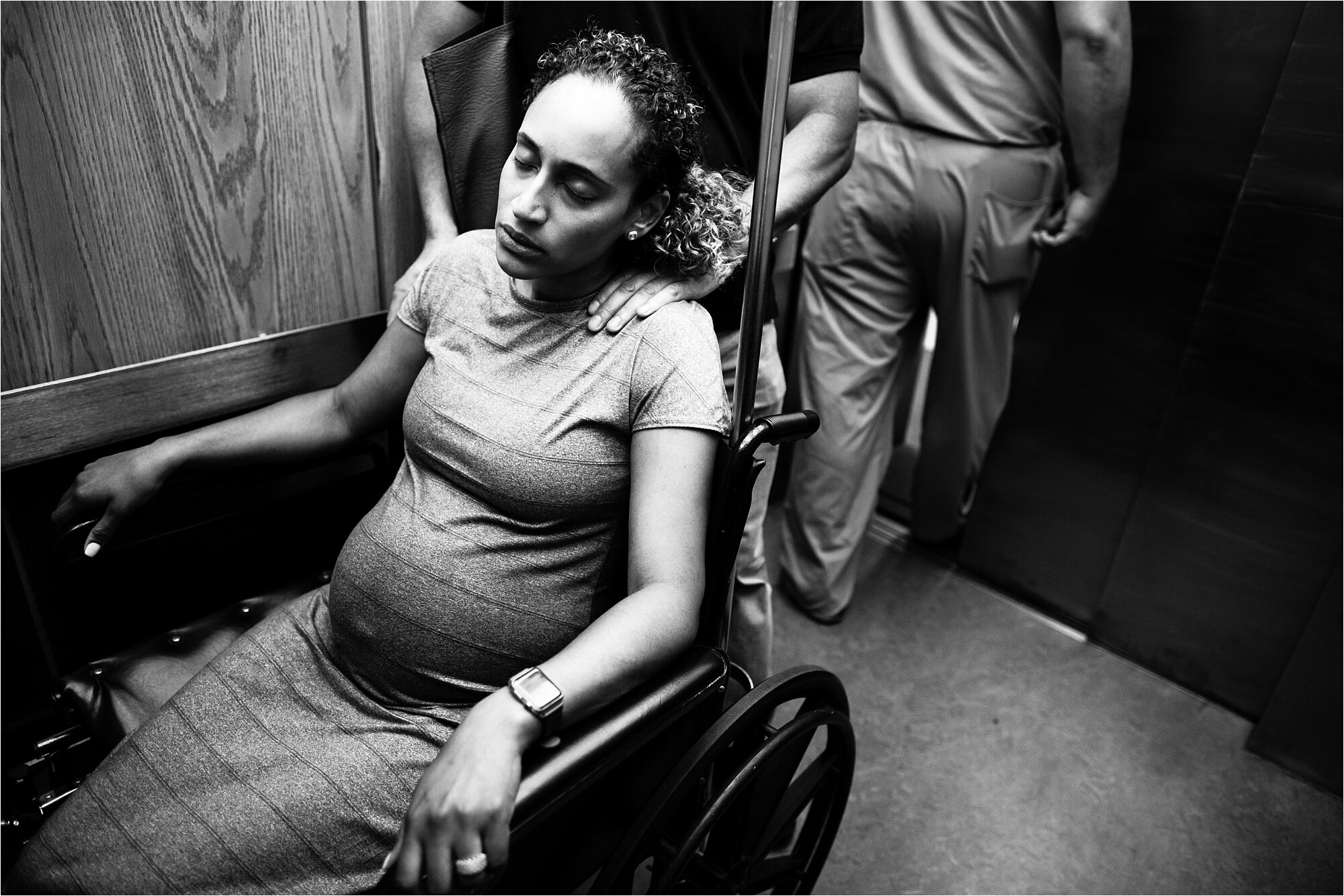 Pregnant mama in labor riding elevator to hospital birth, Philadelphia Photographer