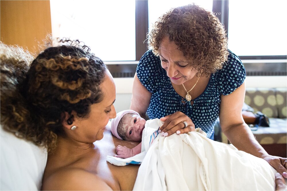Mom and grandma look at minutes old newborn baby girl after fast labor, Philadelphia Hospital Birth Photographer