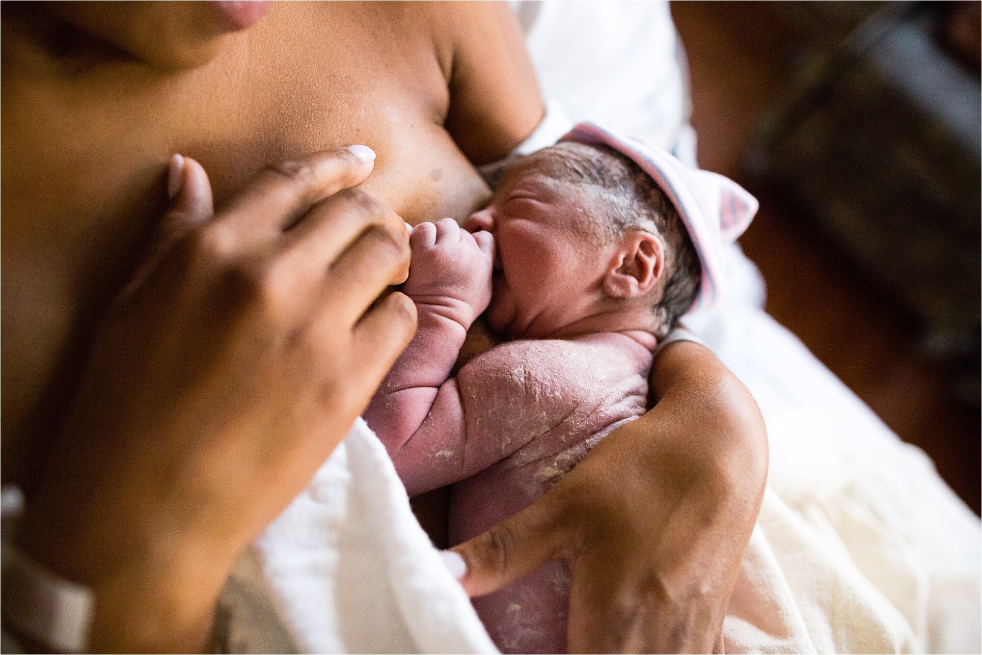 Newborn baby girl breastfeeds for the first time, vernix and skin wrinkles, Philadelphia Birth Photographer