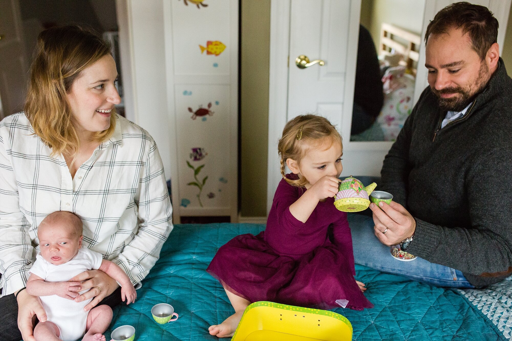 Toddler girl serves tea to her parents while baby brother watches, Philadelphia newborn photographer