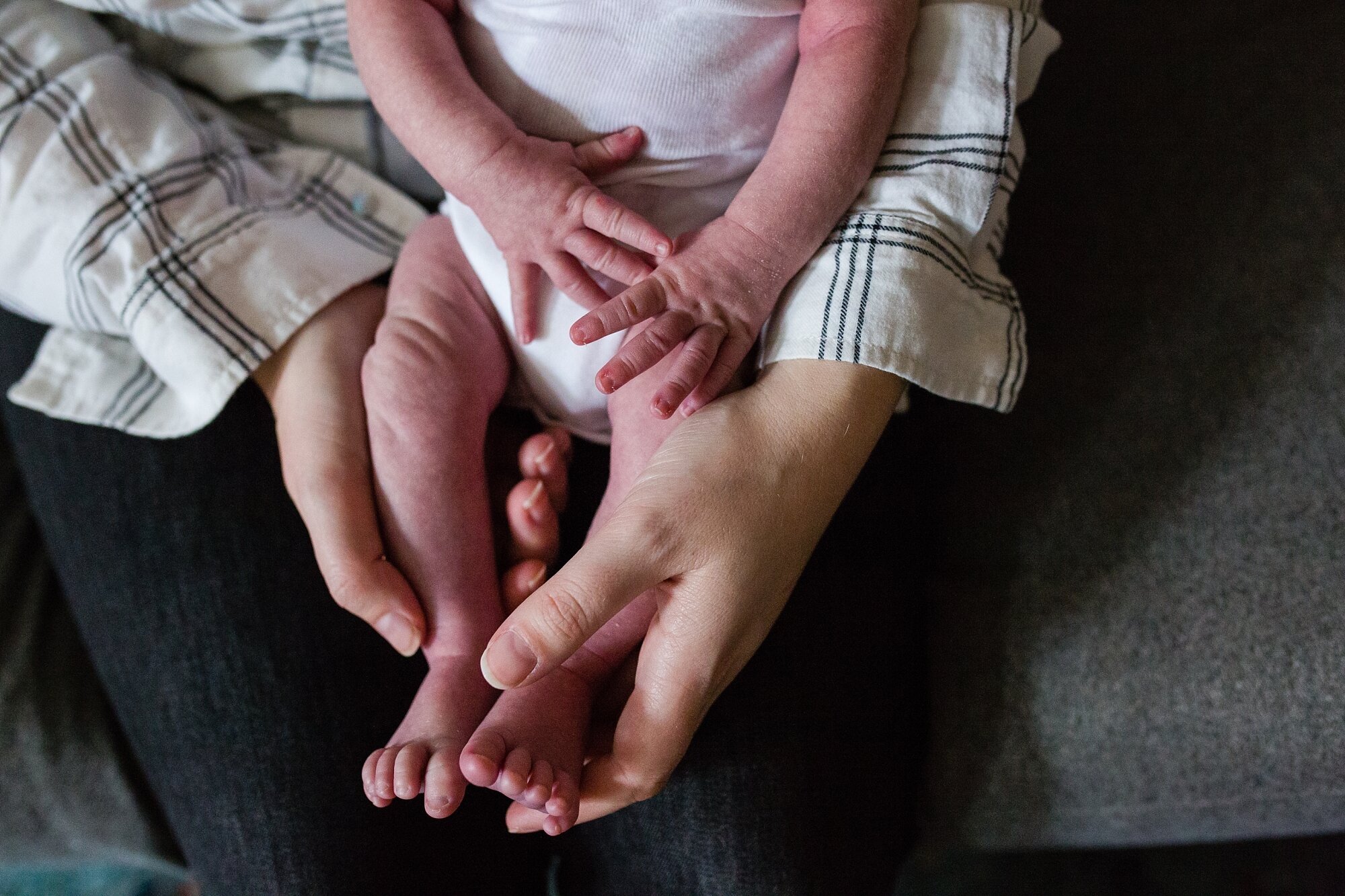 Tiny newborn legs, toes, fingers and hands, in mommy's hands, Philadelphia photographer