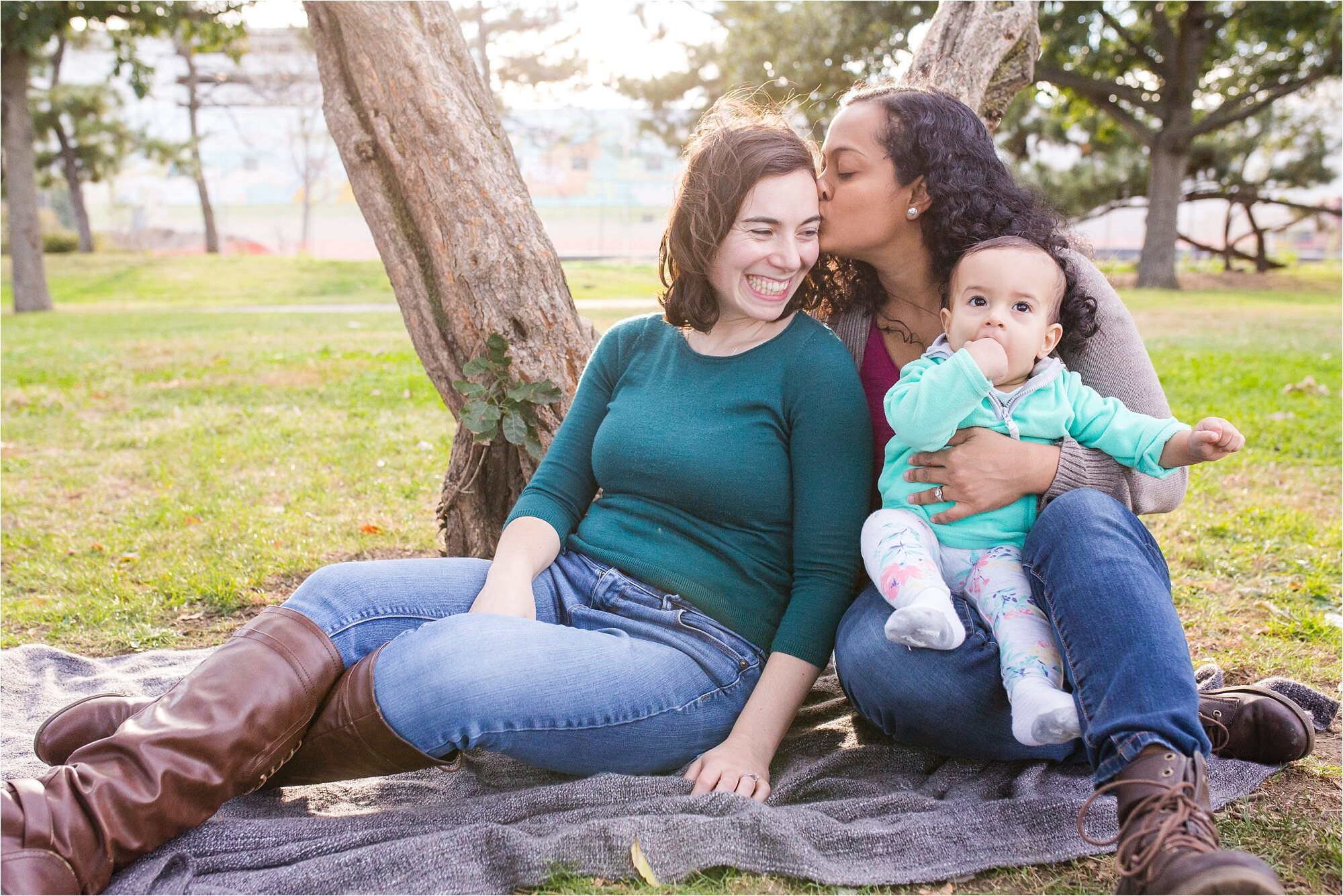 Indian lesbian gay mommies kiss and smile at their baby daughter, Family Photograph Philadelphia