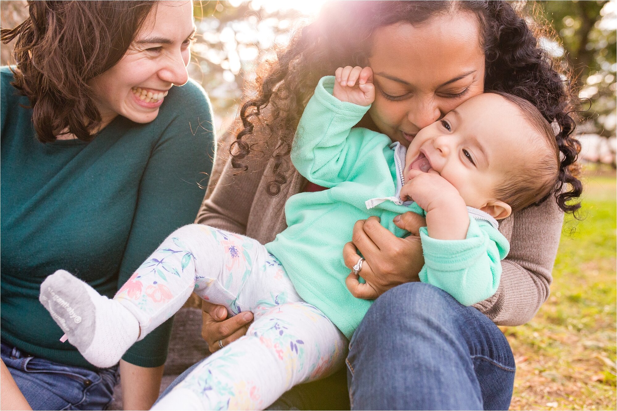 Lesbian gay mommies smile and make their baby daughter laugh, Family Photographer Philadelphia