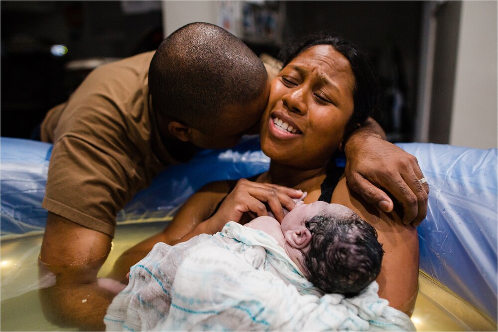 Black family full of joy as new baby is born in home water birth, home hypnobirth Photograph Philadelphia