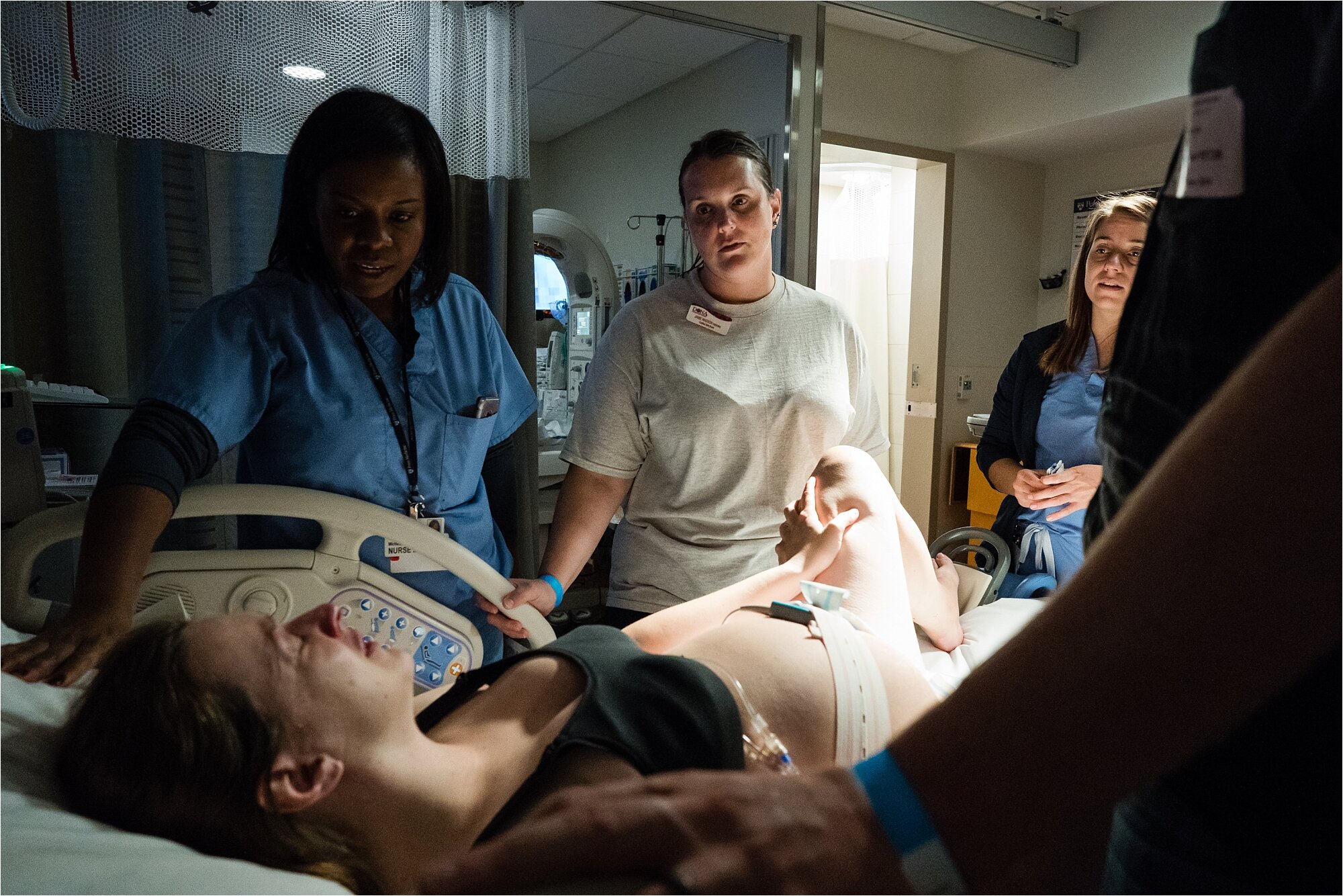 Birth team at hospital comforts distressed mom in labor, midwife, nurse, doula, husband, Philadelphia Birth Photographer