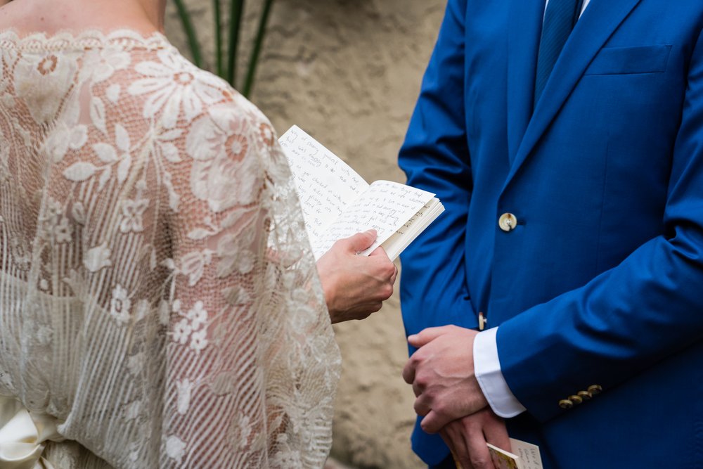 Close up of bride's vows written in a small notebook, groom holding is vows ready to go next, Philadelphia wedding photographer