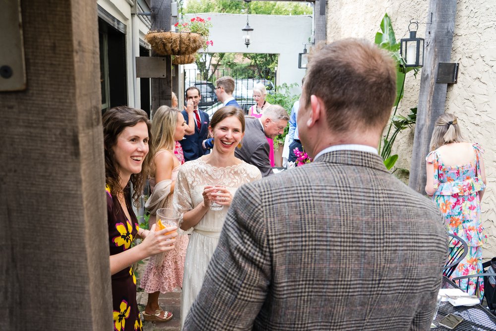 Candid moment of bride laughing with her guests, Philadelphia wedding photographer