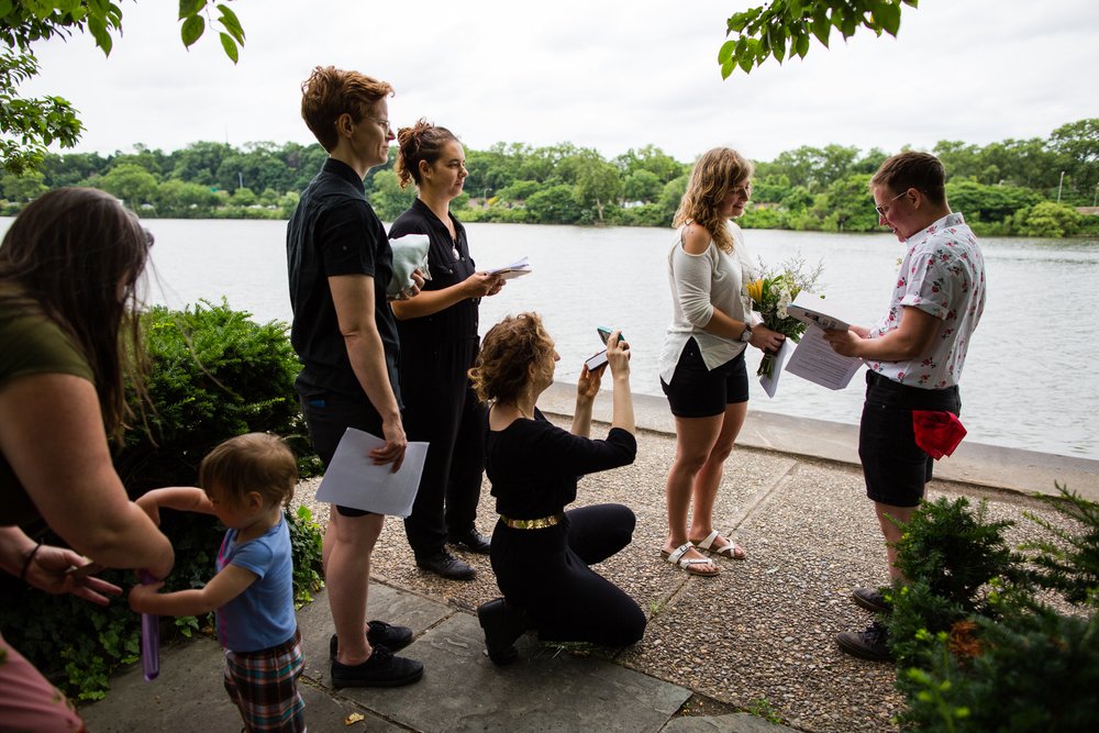 Friends officiate, and hold phones for family to watch couple elope, Philly wedding photographer