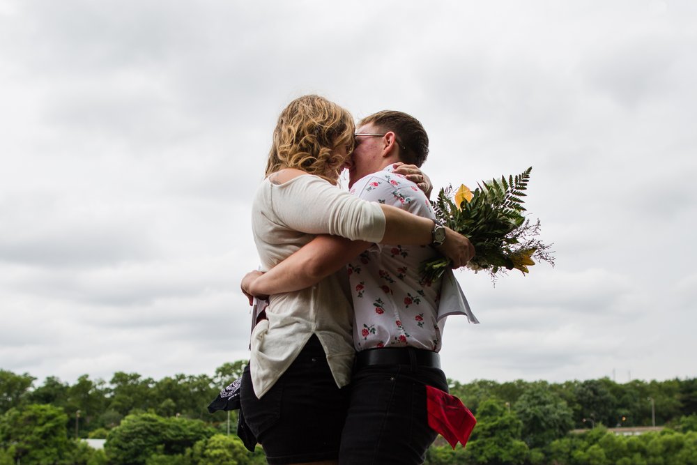 Wedding couple kiss and embrace after eloping by Schuylkill River, Philadelphia wedding photographer