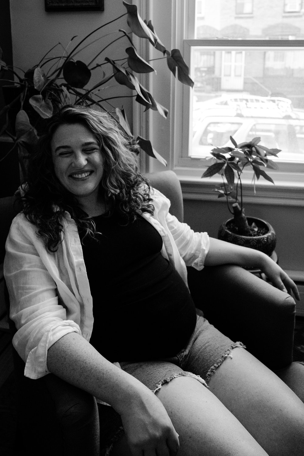 Pregnant mom portrait black and white, beautiful smile in natural window light, Philadelphia maternity photography