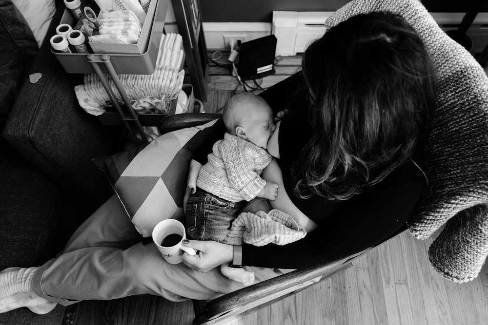 Overhead portrait of mom breastfeeding, holding cup of coffee, black and white, Philadelphia newborn photographer