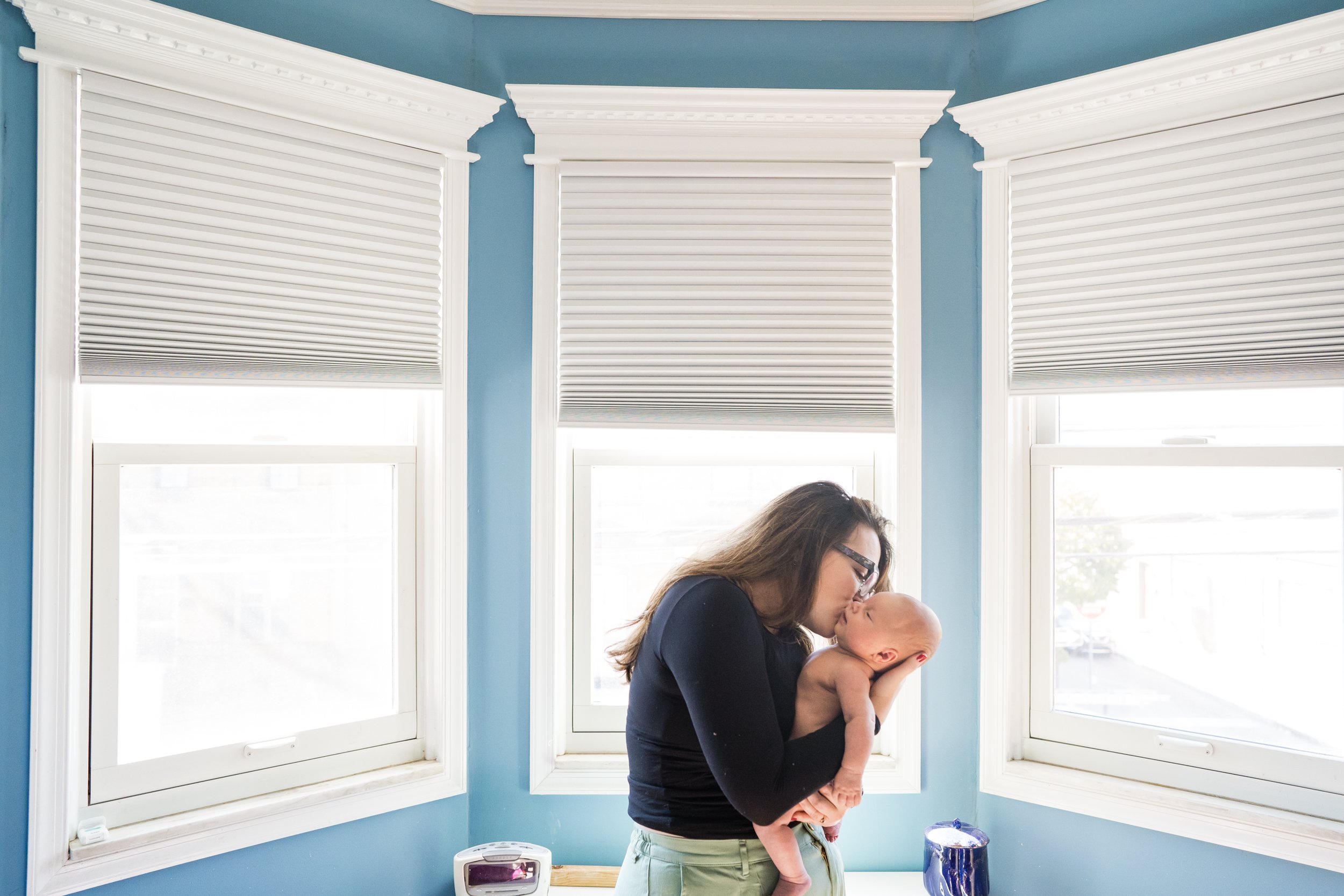 Beautiful portrait of mom kissing baby in front of lovely window light, Philadelphia newborn photography