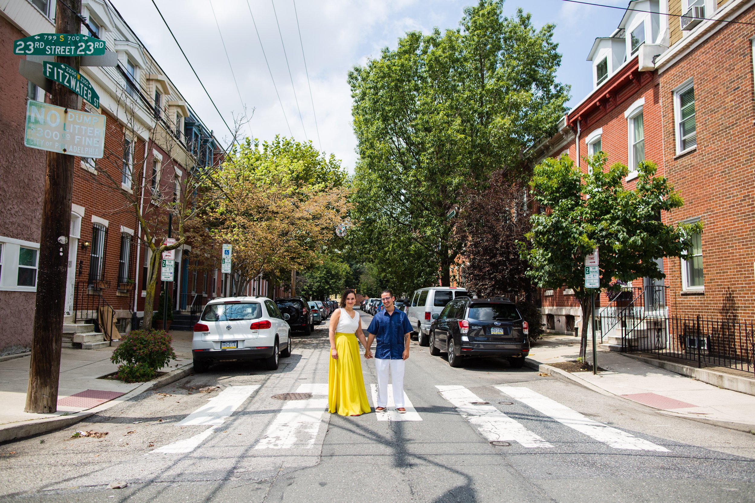 Bride and groom pose in crosswalk of South Philly street, wedding portrait, graduate hospital