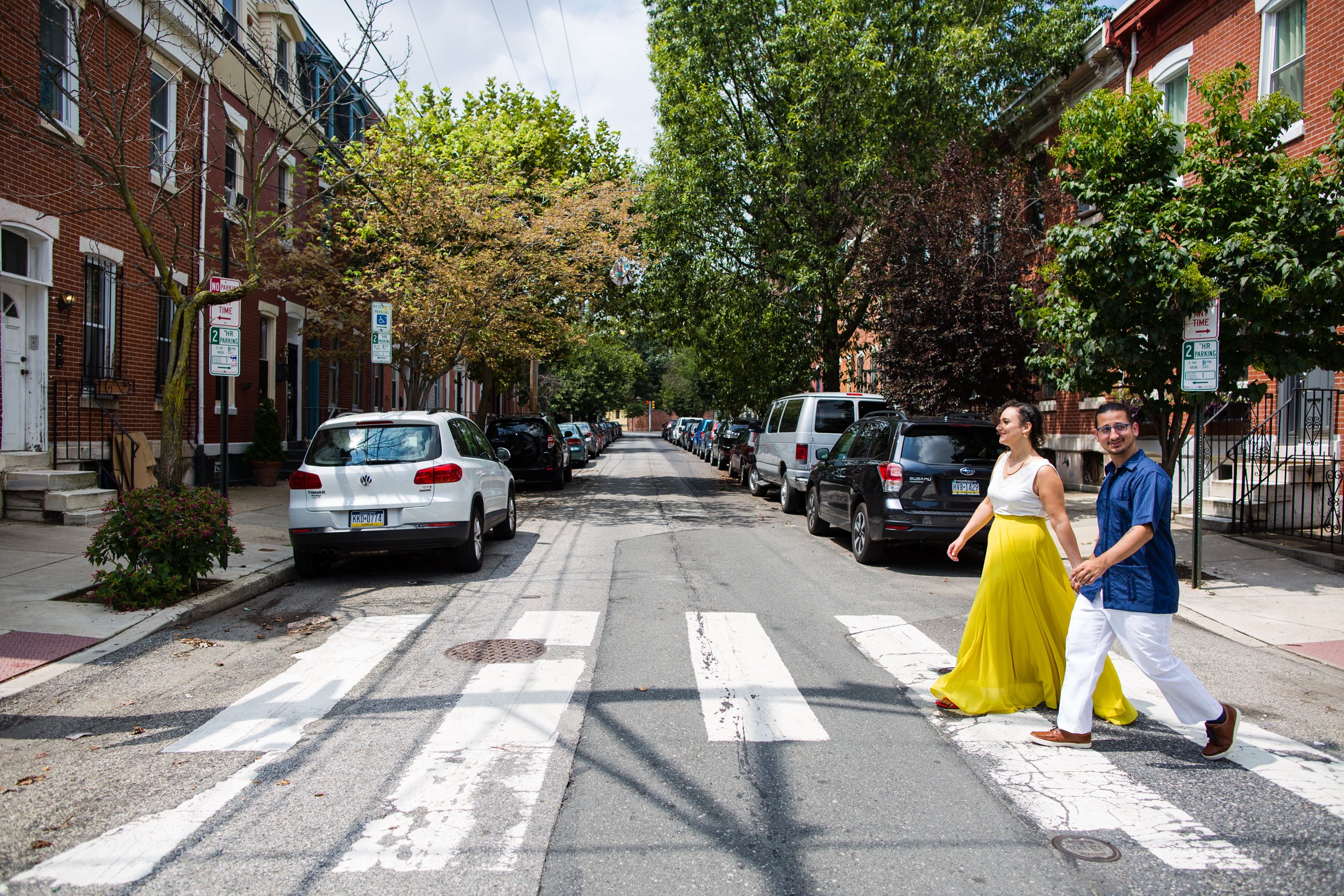 Bride and groom walks across south Philly street, Philadelphia documentary wedding photography