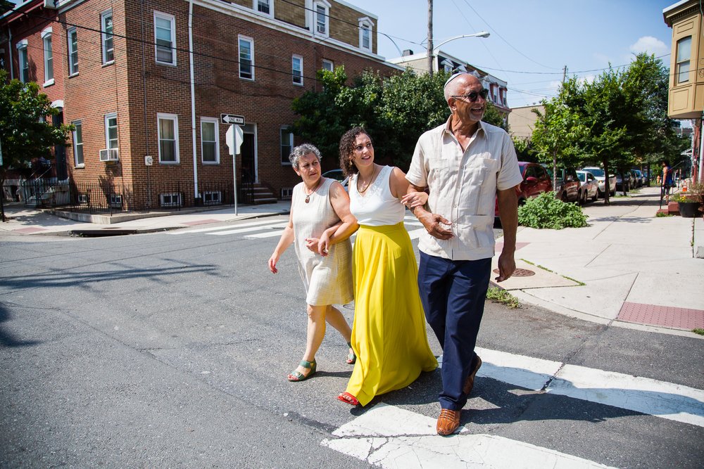 Bride crosses street with parents on the way to chuppah, Philadelphia wedding photographer