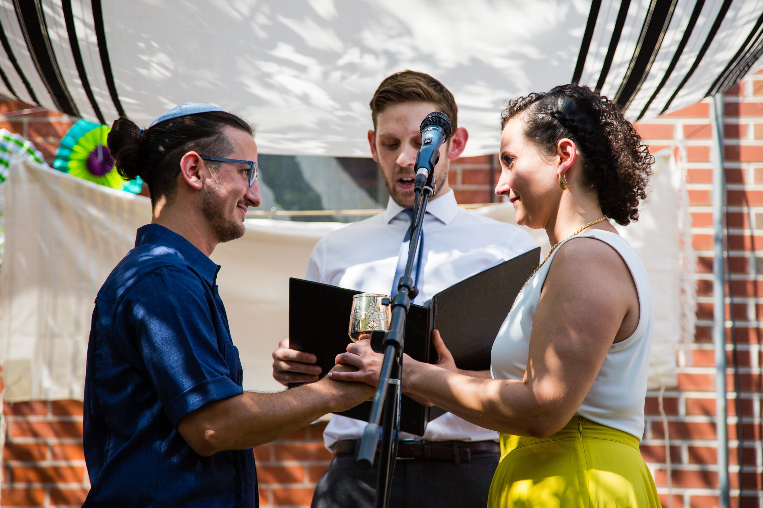 Bride and groom, rabbi, wine glass, chuppah wedding ceremony, Philadelphia photographer