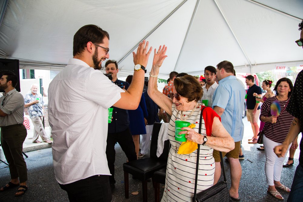 Wedding guests high five at reception dancing, Philadelphia documentary photographer
