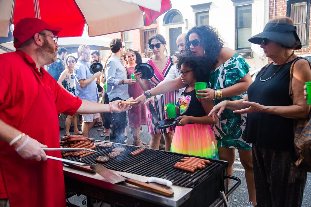 Wedding guests get barbecue at block party reception, Philadelphia documentary photographer