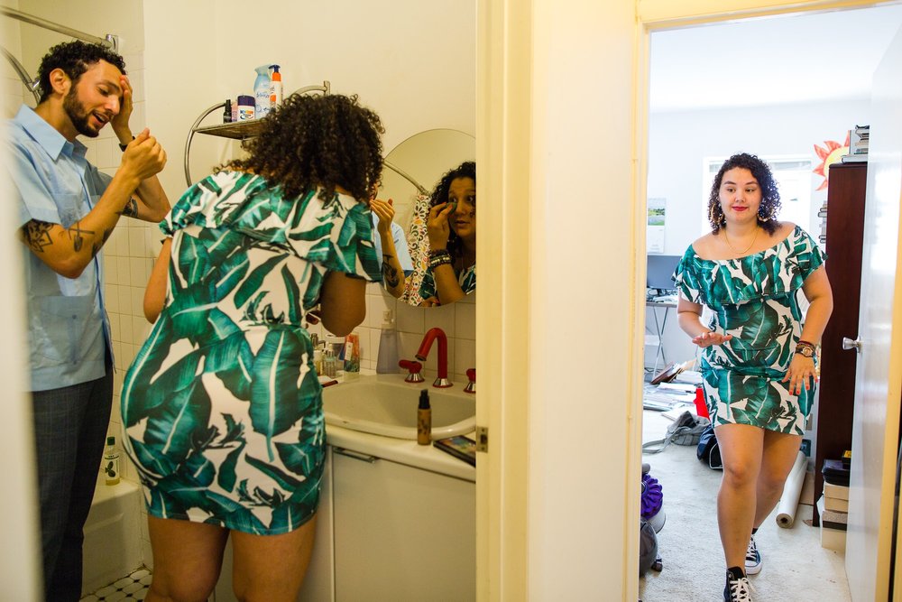 Family gets ready in a South Philly rowhome for block party wedding, split view in bathroom and bedroom, Philly wedding photographer