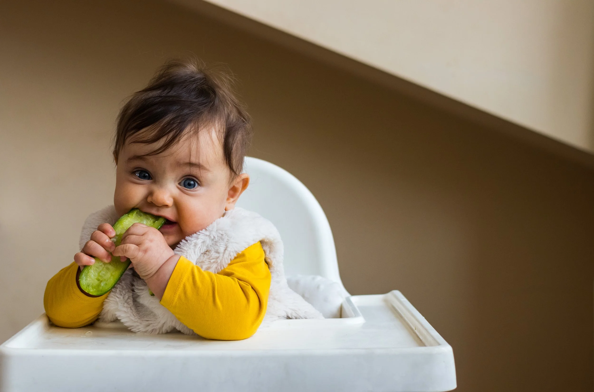 Baby practicing baby-led weaning with avocado