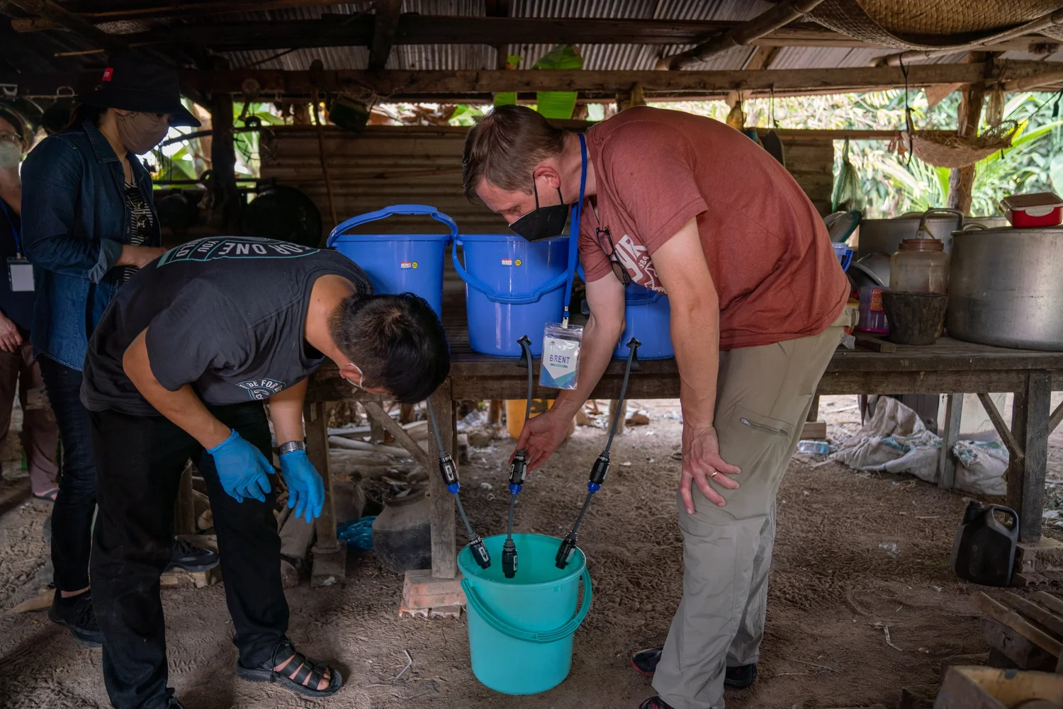 Researchers testing a household water filtration setup in Cambodia