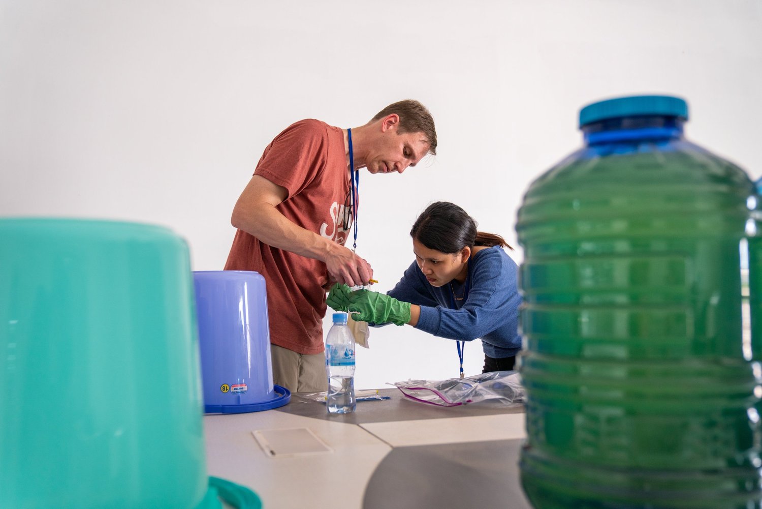 Aquora team performing water quality analysis with a community partner