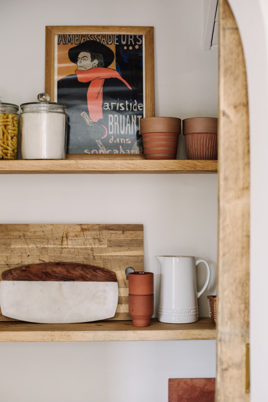 A shelf with pots and pans on it.