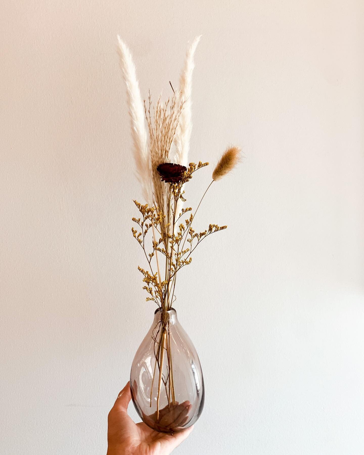 We still have a few different arrangements at the dried flower bar. They range from $18-$30, with the arrangement and glass included. They are the perfect way to add a little bit of flair to your kitchen, bedroom, or living room!