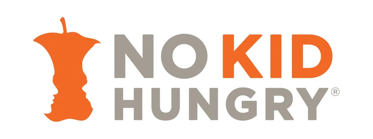 Logo for No Kid Hungry featuring an orange apple core with two faces in profile and the text 'No Kid Hungry' with 'Kid' in orange and the other words in gray.