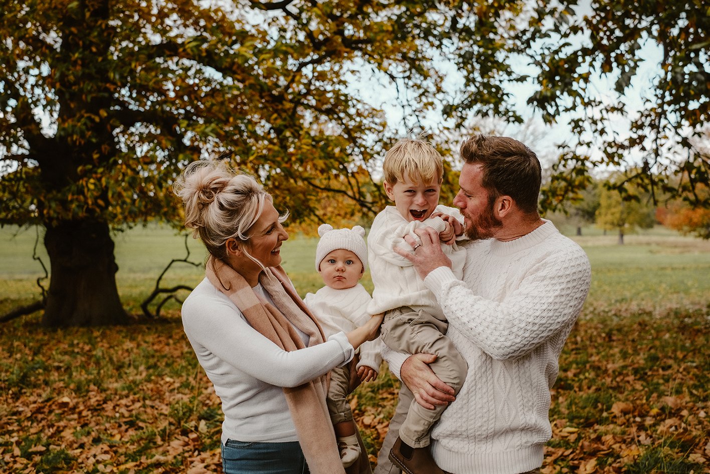 Autumn Photoshoot in the leaves Mum, dad and two babies