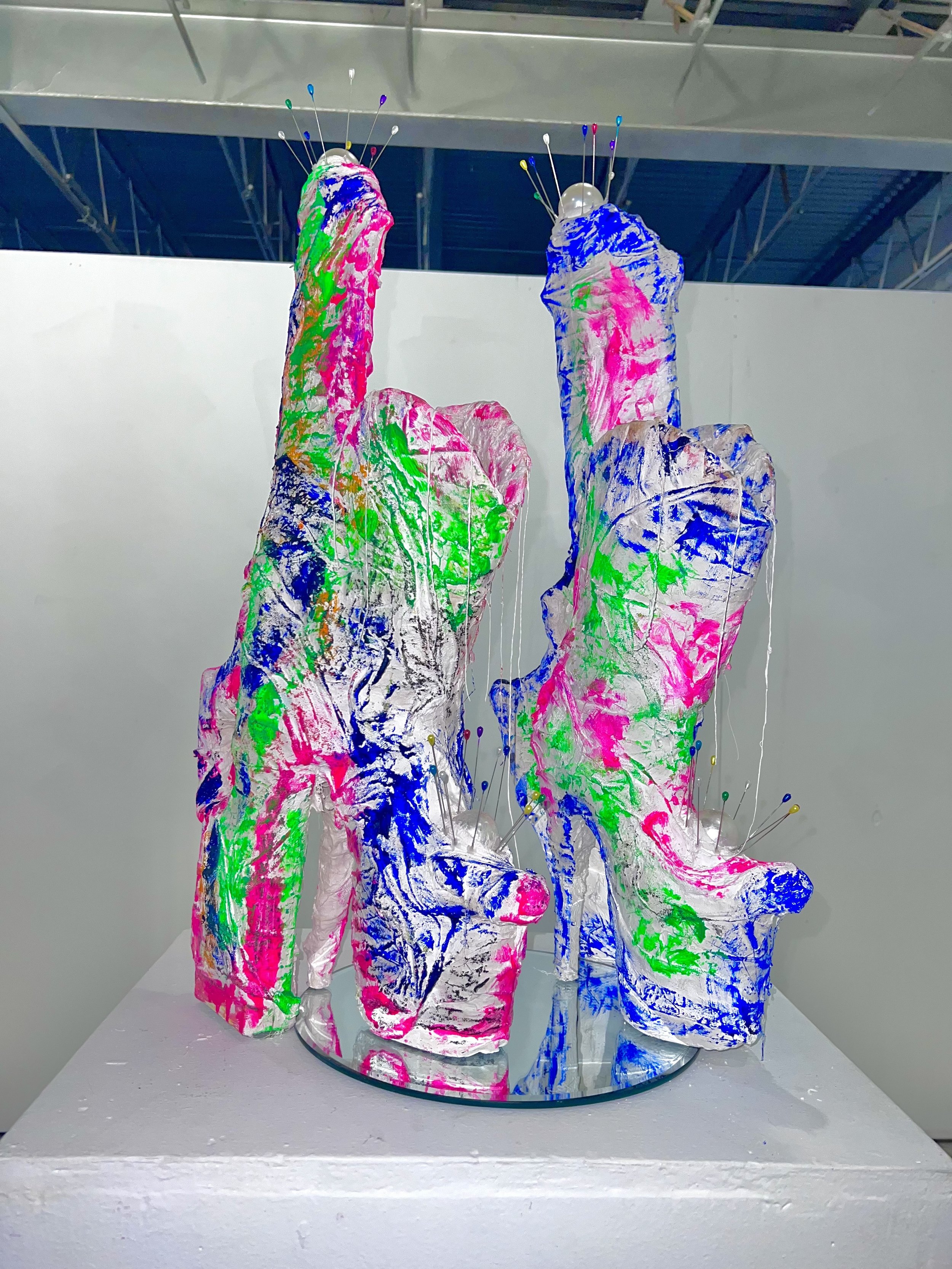 Colorful abstract high-heeled boot sculptures with pins