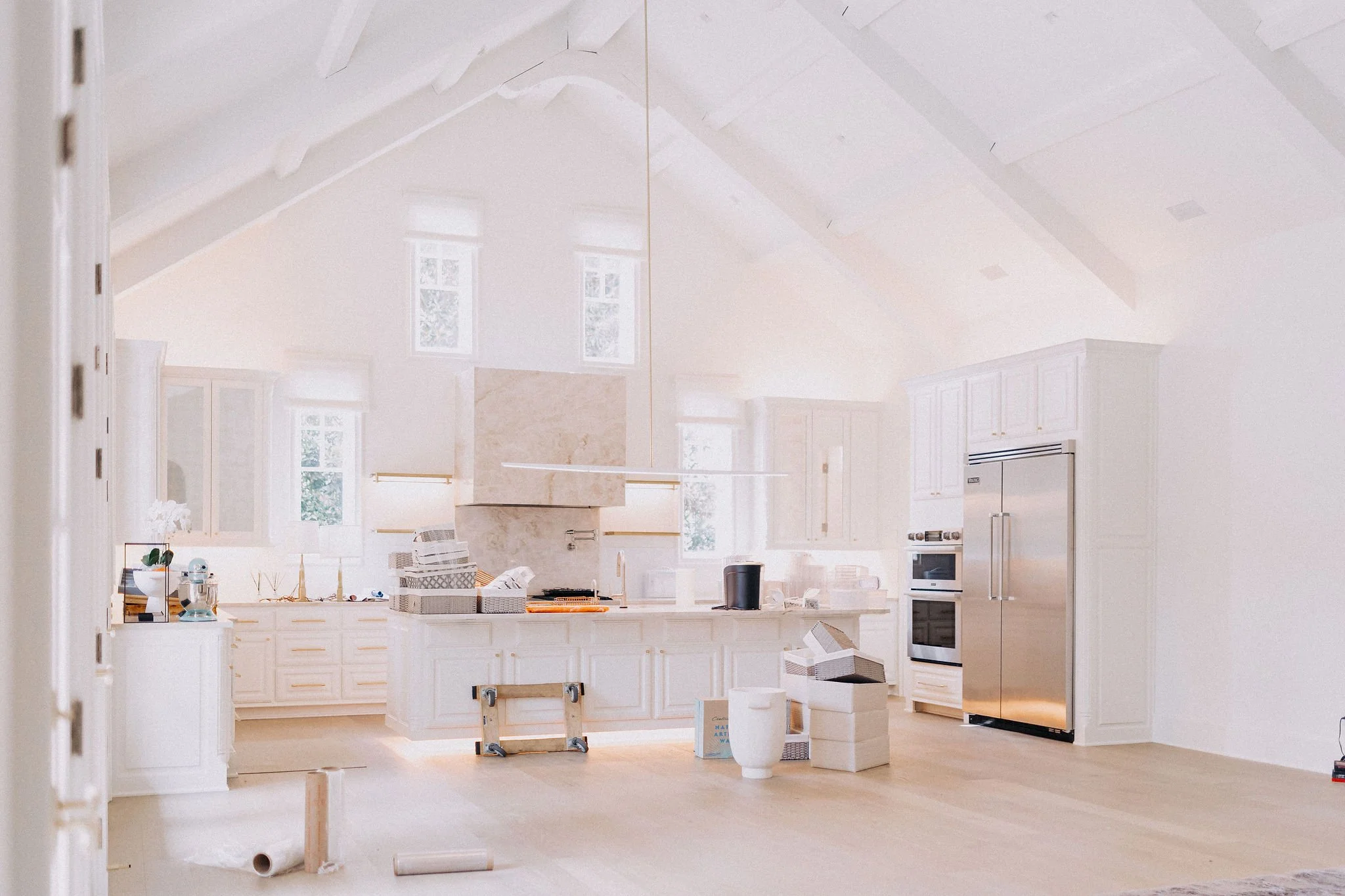 Luxury concierge relocation service unpacking and setting up a high-end kitchen for a move-in ready home