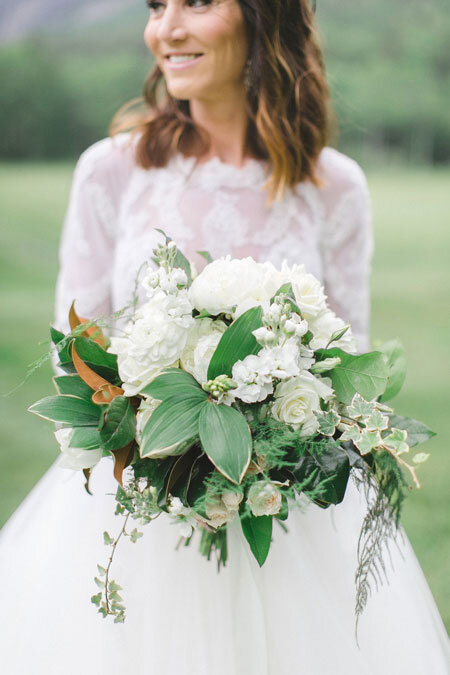 Bride-in-Lace-Dress-and-White-and-Green-Bouquet.jpeg